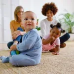 Two Mothers Meeting For Play Date With Babies At Home In Loft Apartment